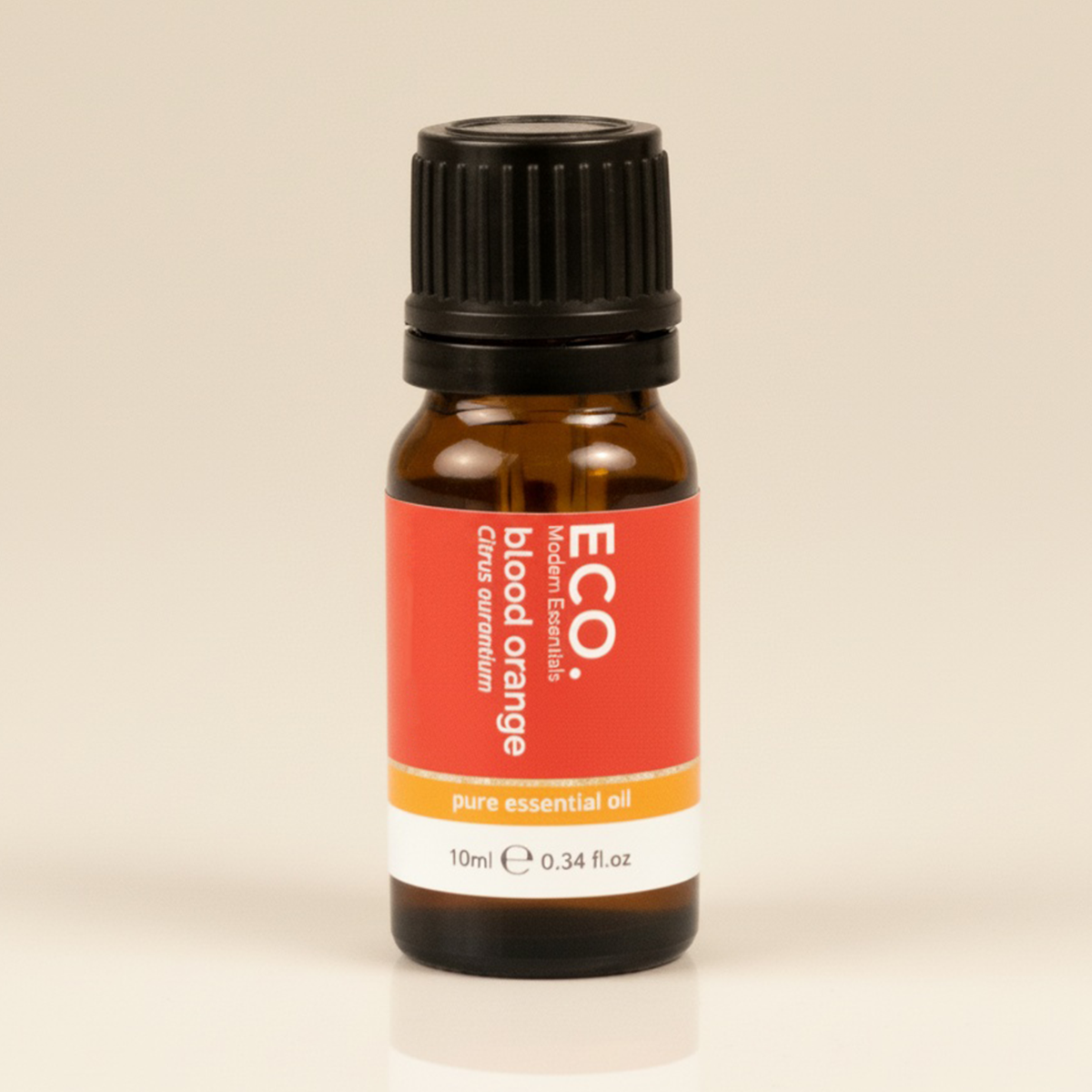 Bottle of ECO blood orange essential oil on a beige background