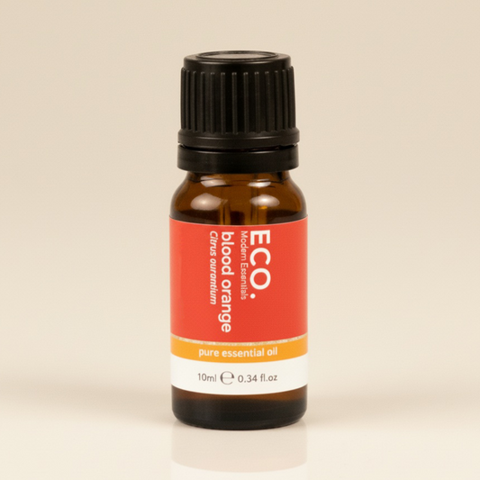 Bottle of ECO blood orange essential oil on a beige background