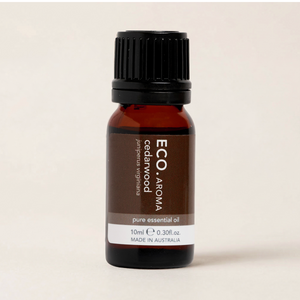 Brown essential oil bottle with black cap on a beige background