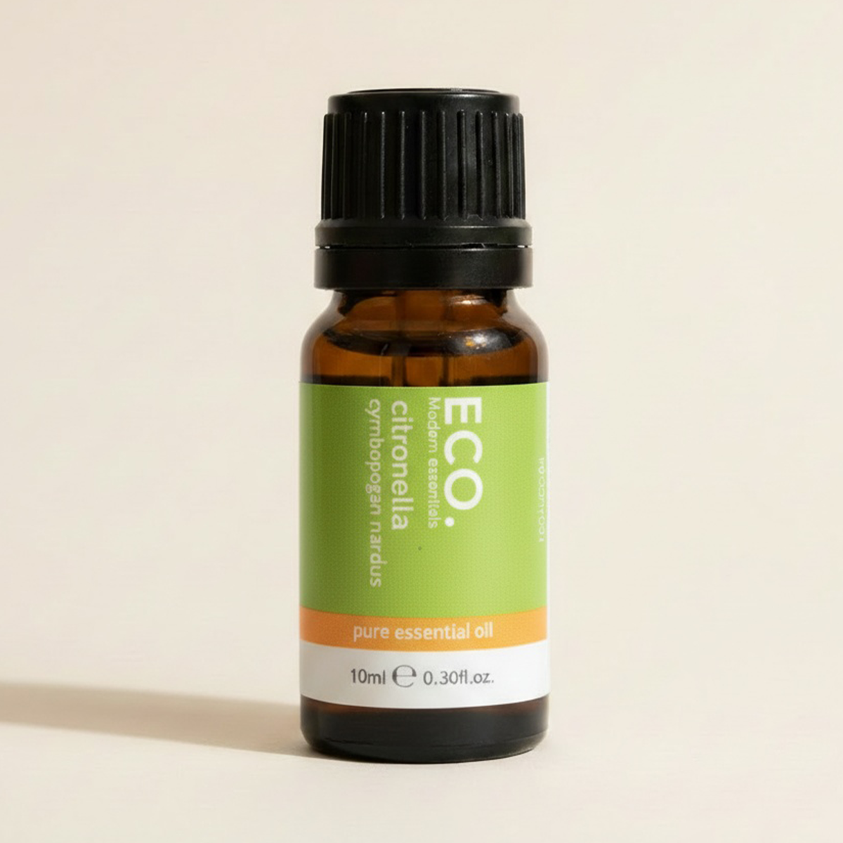 Bottle of ECO citronella pure essential oil on a beige background