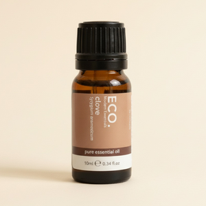 Brown essential oil bottle with black cap on a beige background
