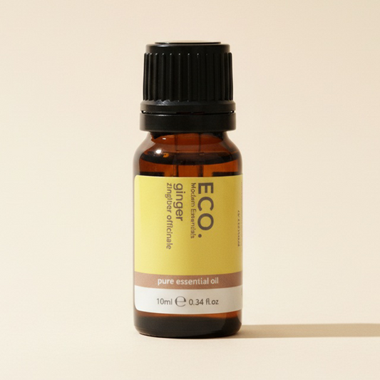 Bottle of ECO ginger pure essential oil on a beige background