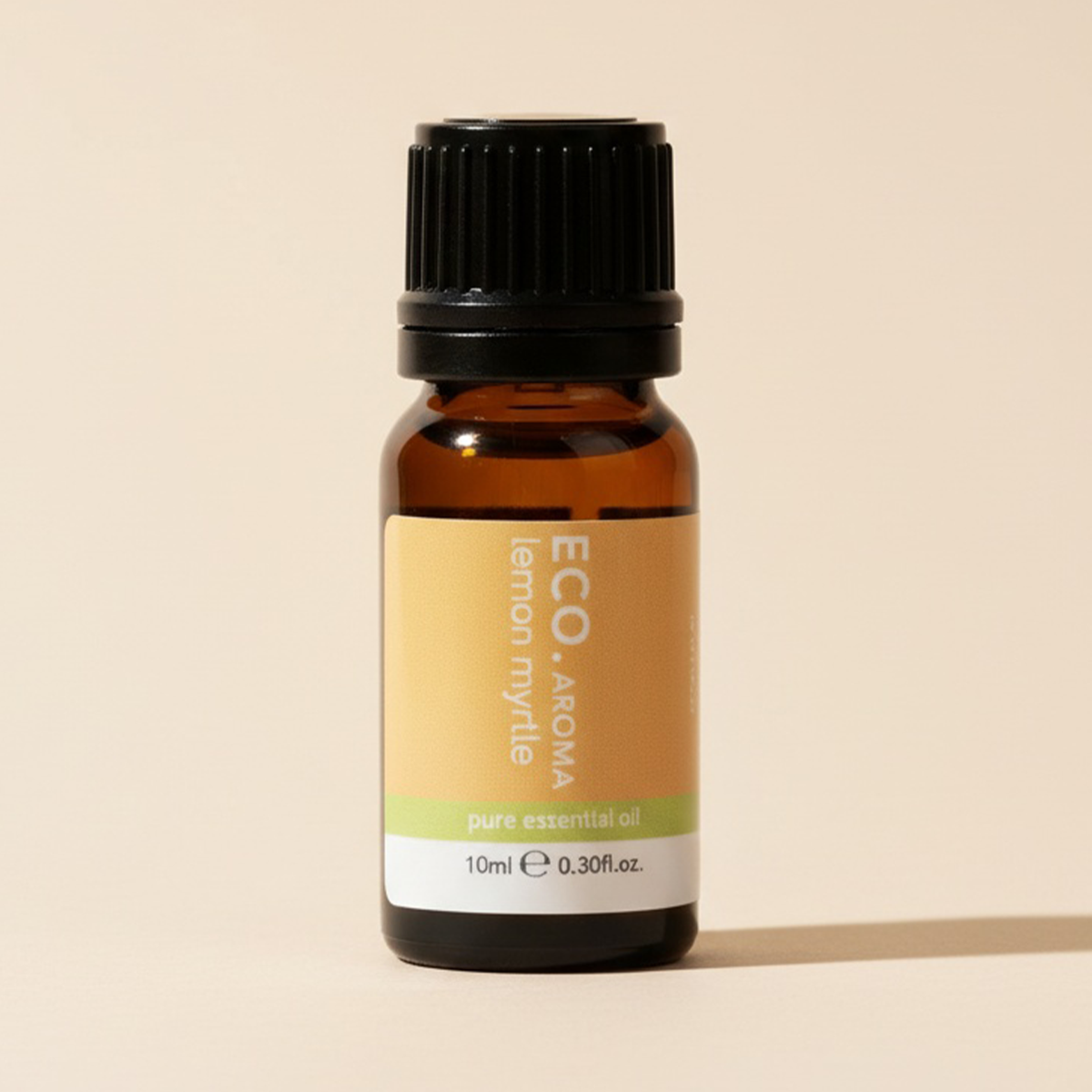 Brown glass bottle of ECO Aroma lemon myrtle essential oil on a beige background