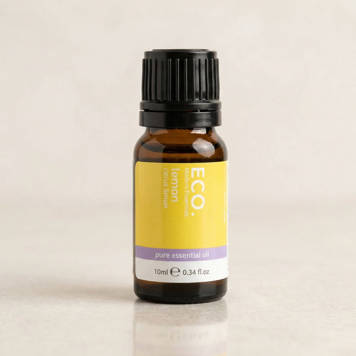 Bottle of ECO lemon pure essential oil on a beige background