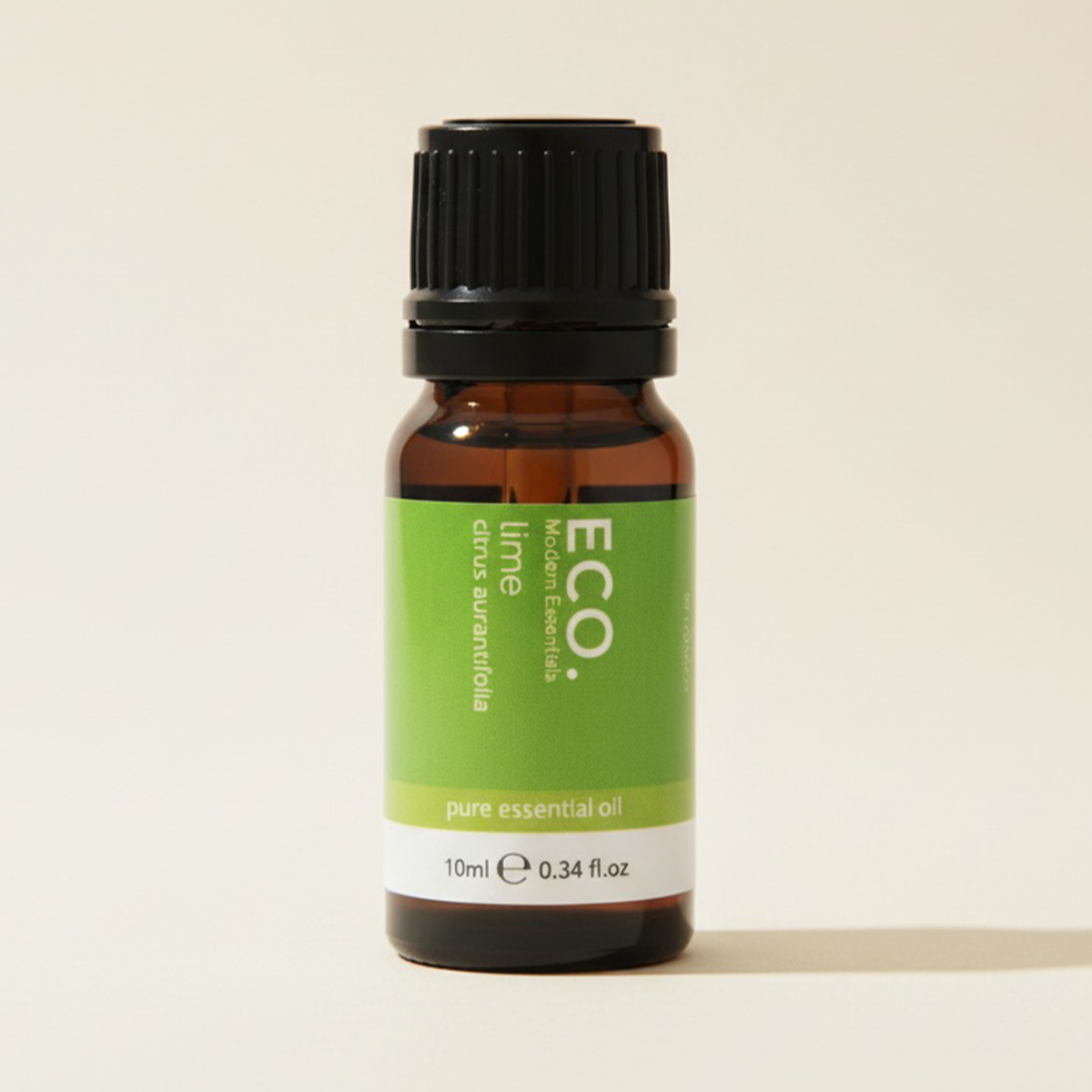 Bottle of ECO lime pure essential oil on a beige background