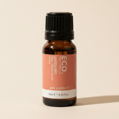 Brown essential oil bottle with a black cap on a beige background