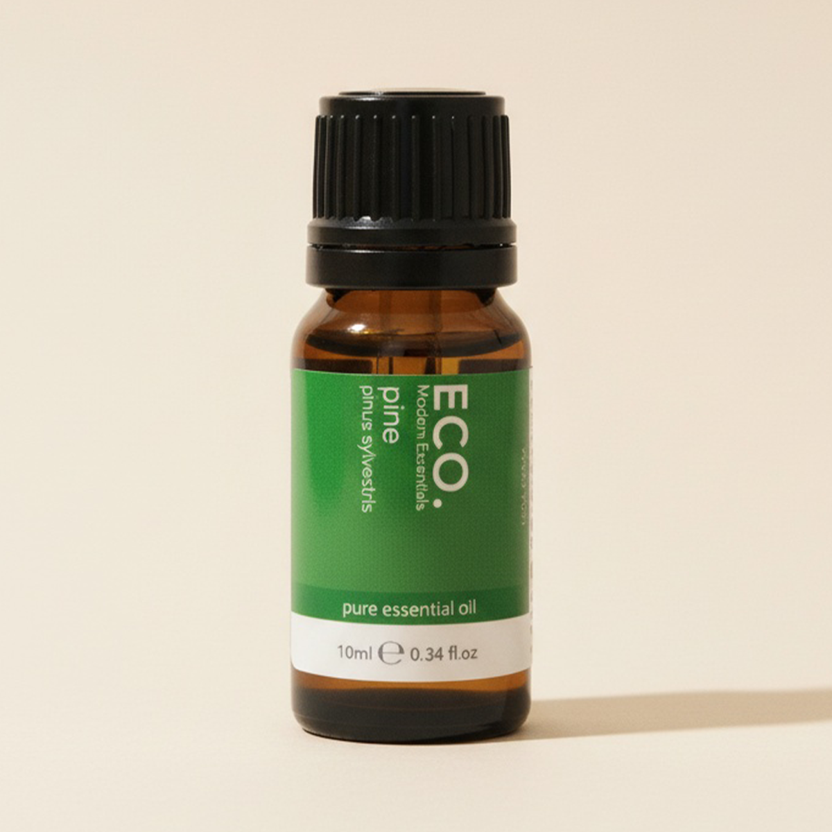 Brown glass bottle with green label on a beige background