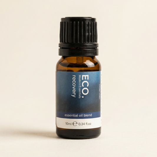 Bottle of ECO. Modern Essentials recovery essential oil blend on a beige background