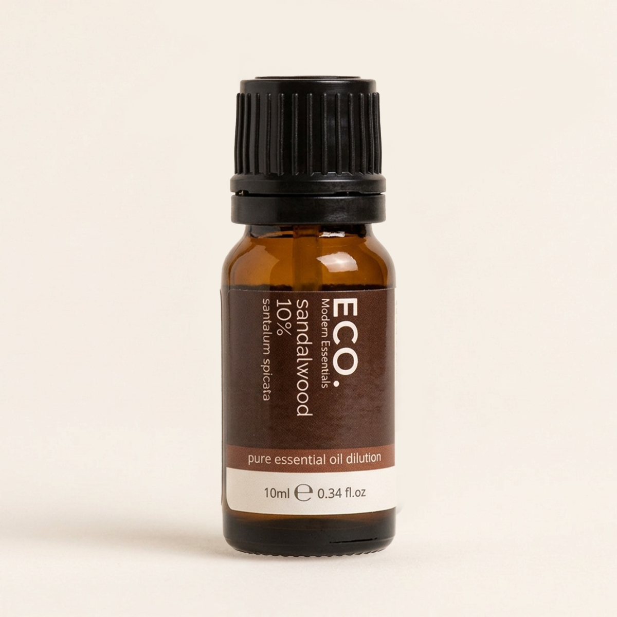 Bottle of ECO Sandalwood essential oil on a beige background