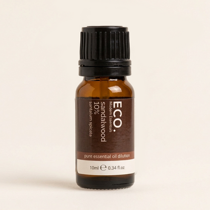 Bottle of ECO Sandalwood essential oil on a beige background