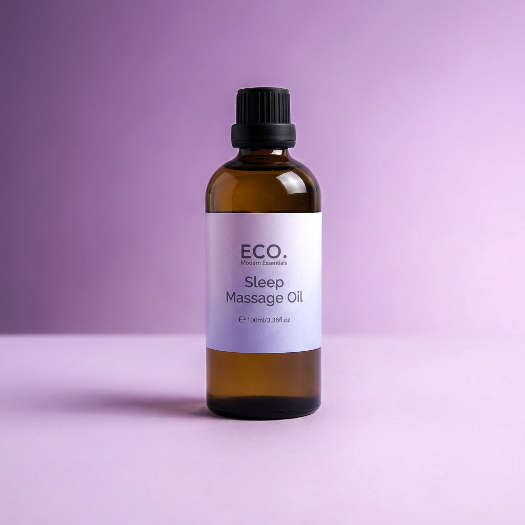Bottle of ECO Sleep Massage Oil on a purple background