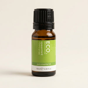Bottle of ECO spearmint pure essential oil on a beige background