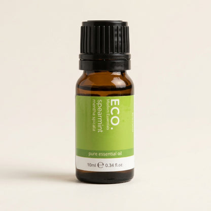 Bottle of ECO spearmint pure essential oil on a beige background