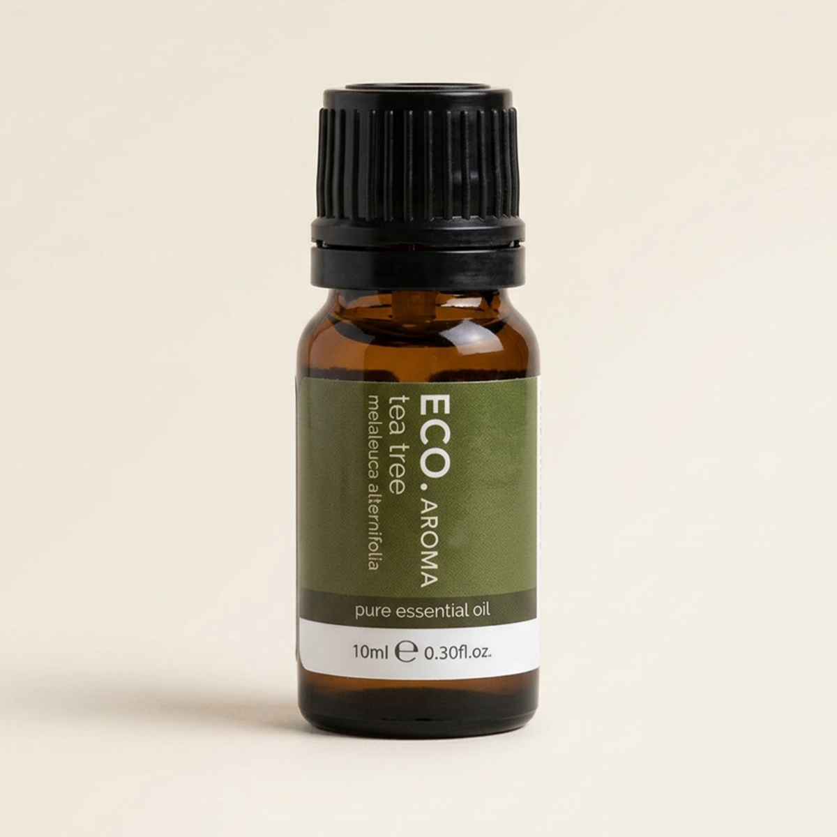 Bottle of ECO Aroma tea tree pure essential oil on a beige background