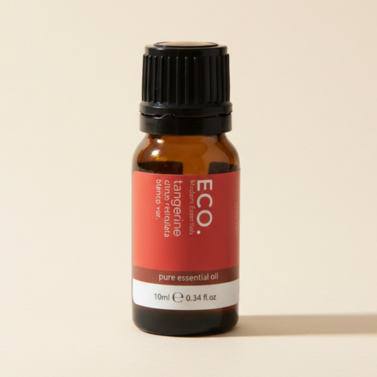 Bottle of ECO tangerine essential oil on a beige background