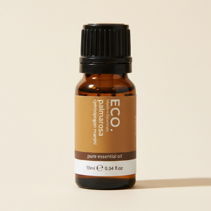 Brown essential oil bottle with black cap on a beige background