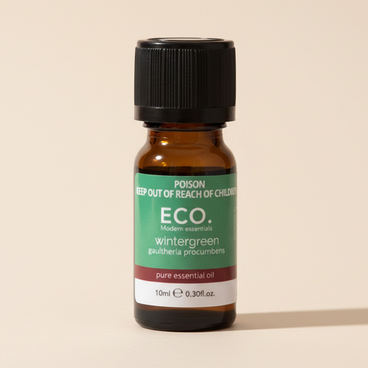 Bottle of ECO wintergreen essential oil on a beige background