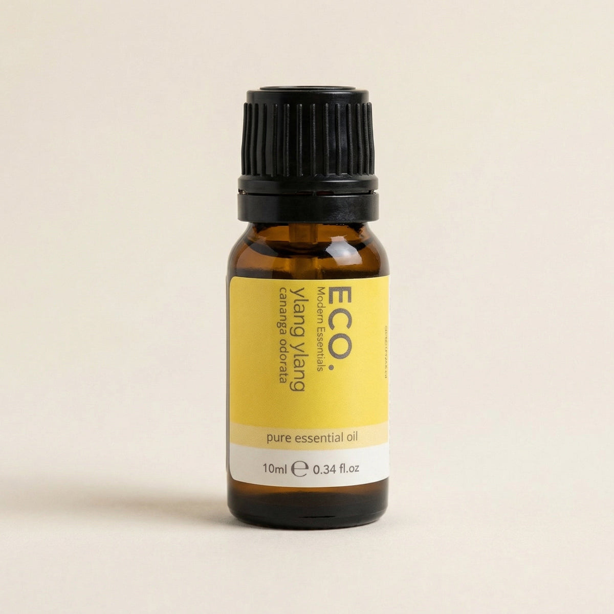 Bottle of ECO Ylang Ylang pure essential oil on a beige background