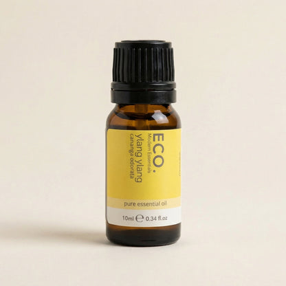 Bottle of ECO Ylang Ylang pure essential oil on a beige background