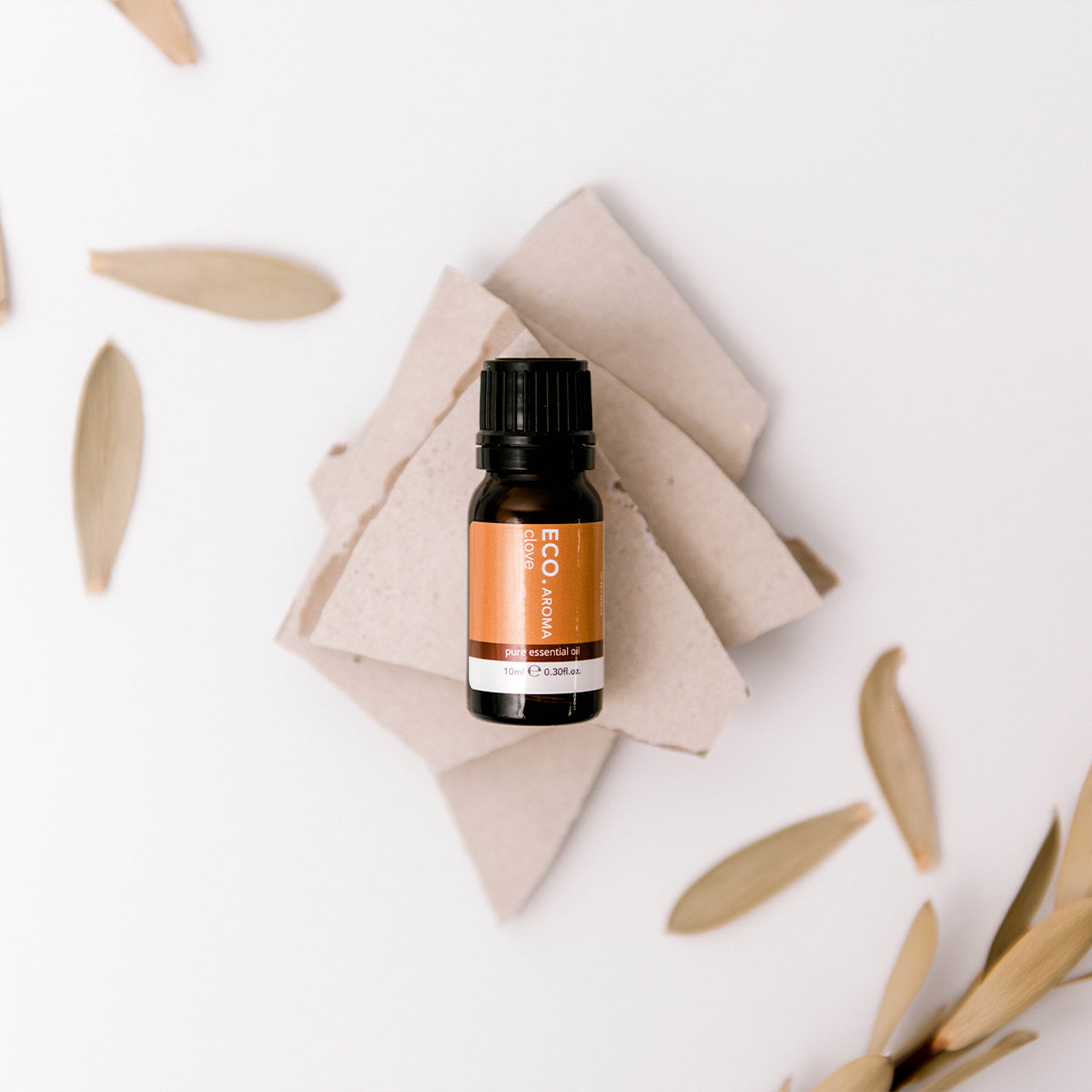Clove oil with leaves in the background