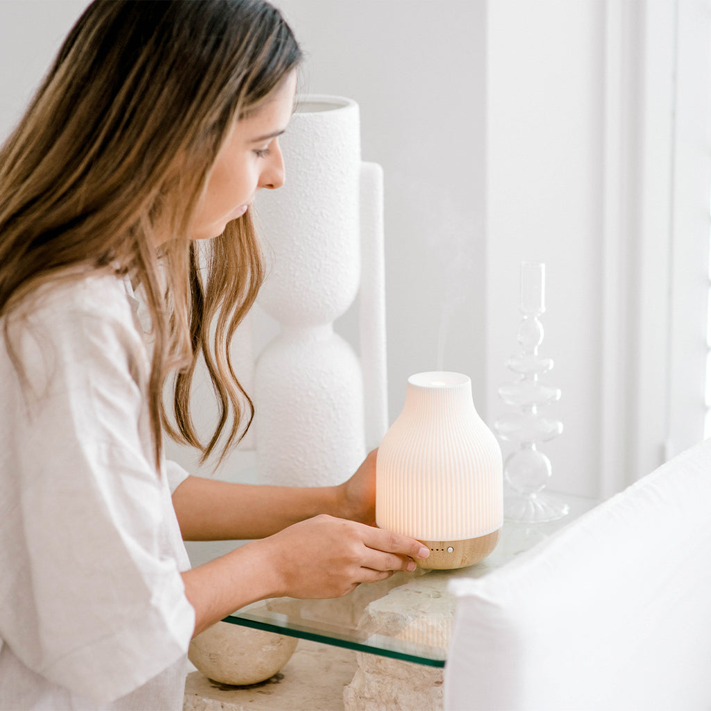 woman sets up essential oil diffuser