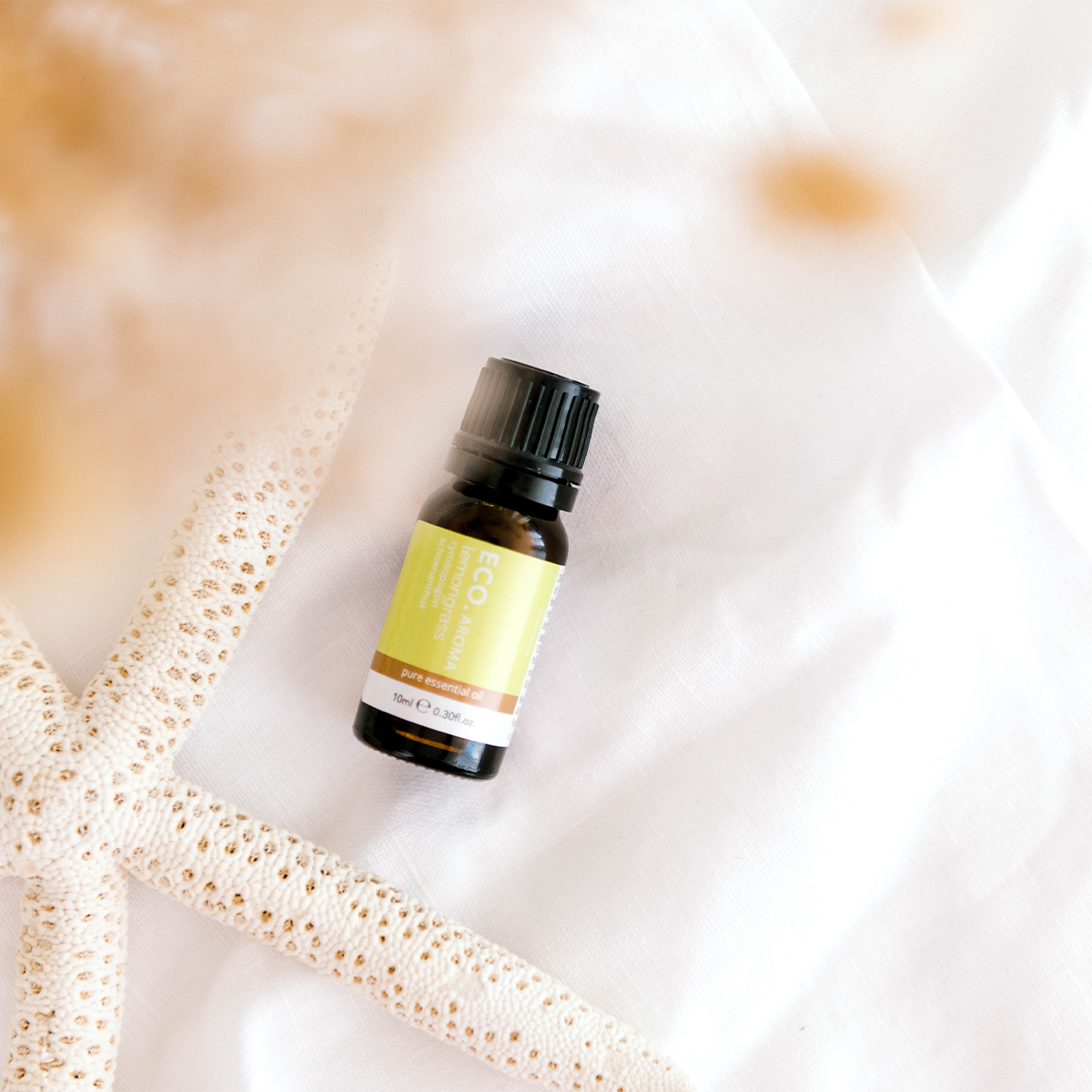 Lemongrass essential oil bottle with starfish